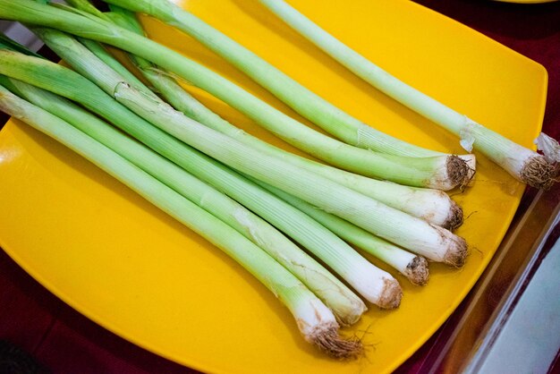 Collection of fresh onion scallions on a plate