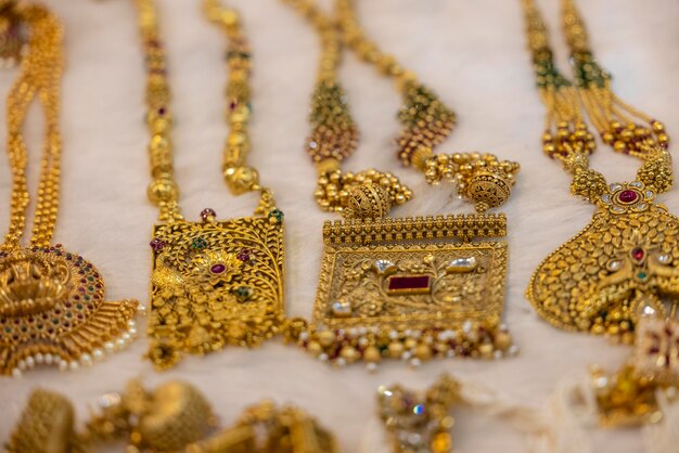 A collection of gold jewellery is displayed in a shop.