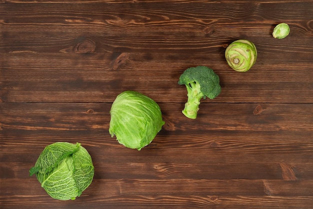 Collection of green vegetables produce on dark background broccolini avocado squash chilli grapes part of flat lay overhead set