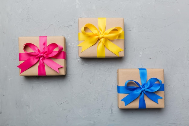 Collection of Holiday present boxes on a colored background. top view close up.