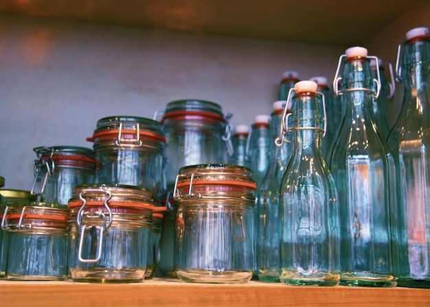 A collection of jars and bottles on a shelf.