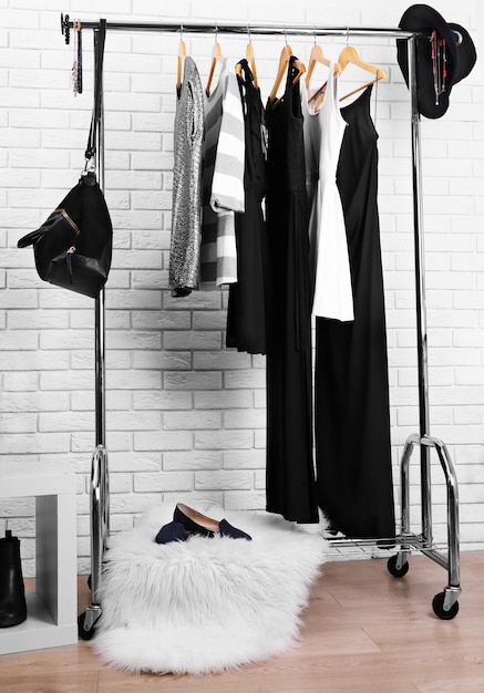 Collection of male and female clothes hanging on a rack