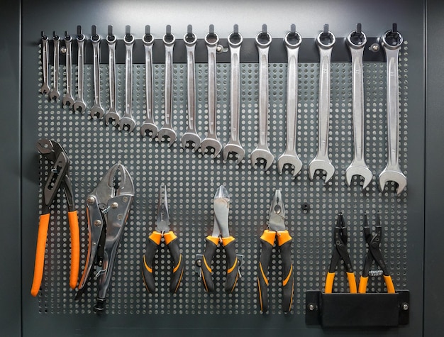 Photo collection of mechanic hand tools hanging on tool board