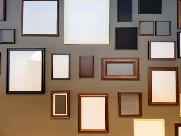 A Collection of Memories Empty Picture Frames of Different Colors and Textures on a Gray Wall