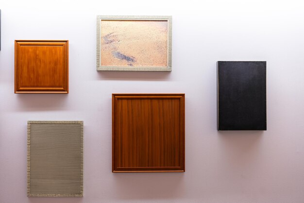 A Collection of Memories Empty Picture Frames of Different Colors and Textures on a white Wall