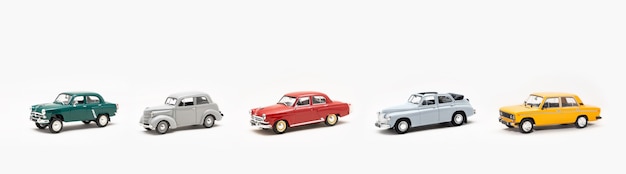 Collection of miniature replicas of toy vintage cars on a white background