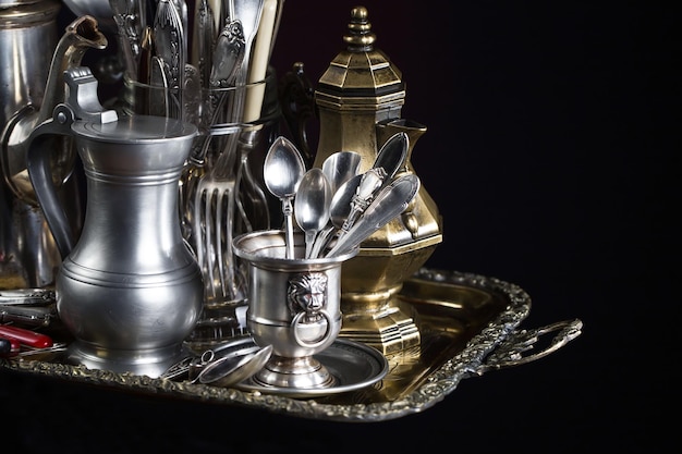 A collection of old kitchen utensils on a wooden table.