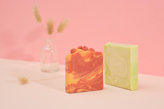 Photo collection of organic handmade soaps with lime and berries on a pink background spa at your home