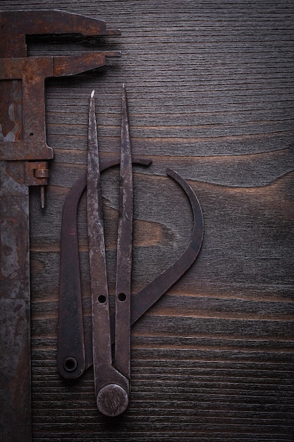 Collection of rusty vernier scales on vintage wooden board