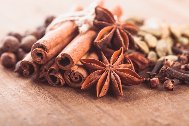 Collection of spices for mulled wine and pastry on the wooden table