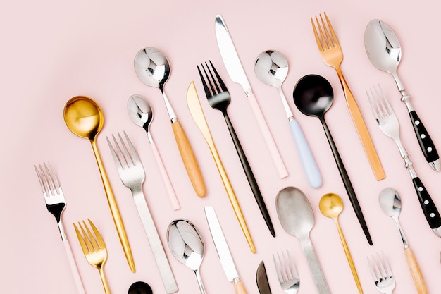 Collection of various cutlery on pastel background, flat lay, top view,