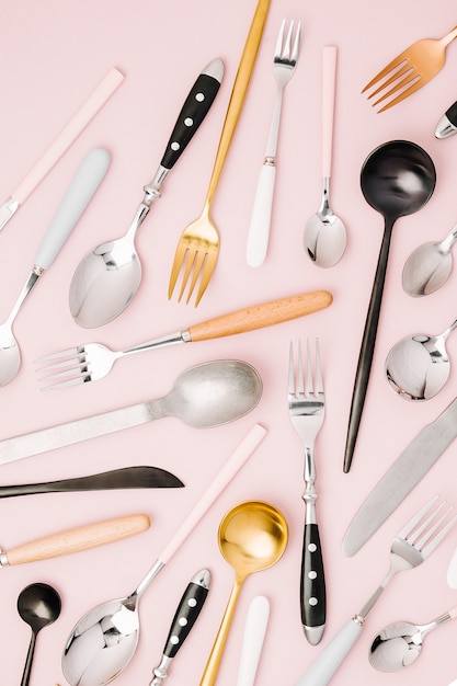 Collection of various cutlery on pastel background, flat lay, top view,