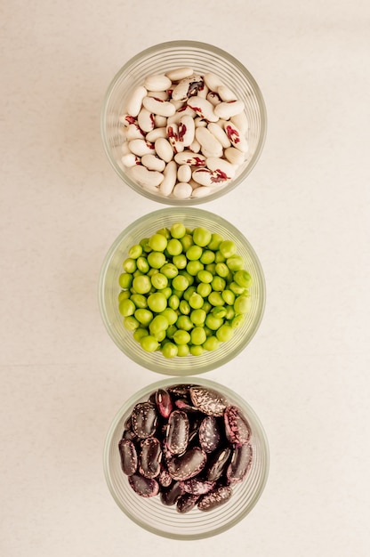 Collection of various dried legumes in glasses