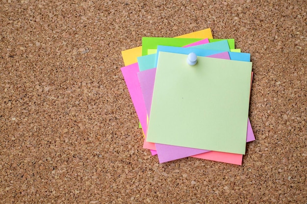 Collection of various note papers on corkboard