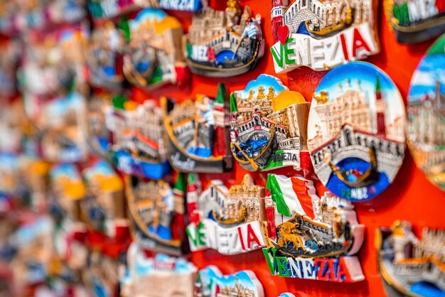 Collection of various travel magnet souvenirs on display for tourists