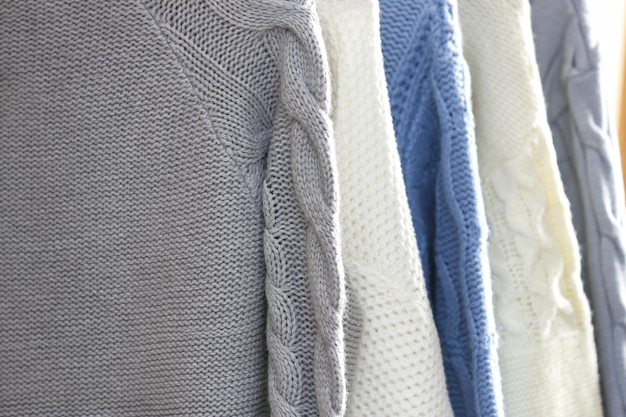 Photo collection of warm sweaters as background closeup