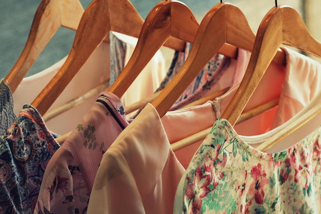 collection of womens clothes hanging on rack for sale