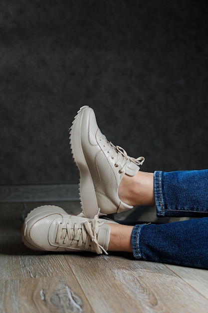 Collection of womens leather shoes Female legs in leather beige casual sneakers Stylish womens sneakers