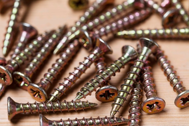 Collection of woodworking DIY home improvement screws on a wood background