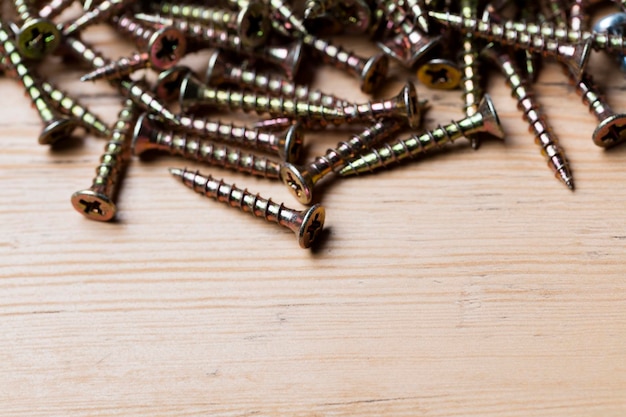 Collection of woodworking DIY home improvement screws on a wood background
