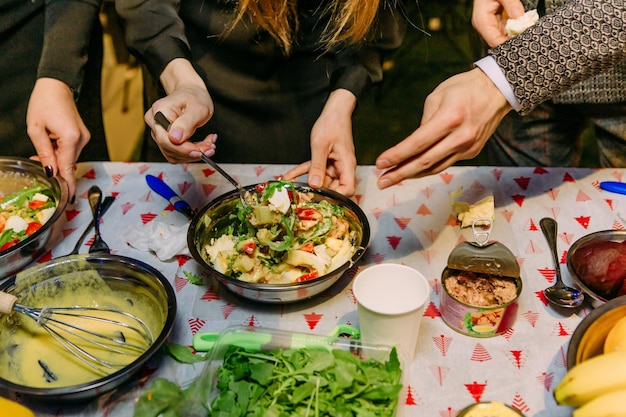 Collective cooking salad food in the kitchen eggs canned food tomato pepper fish