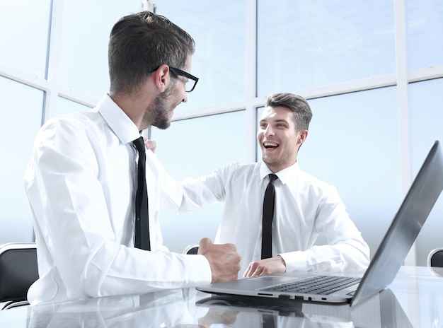 Collega's zitten aan tafel en praten