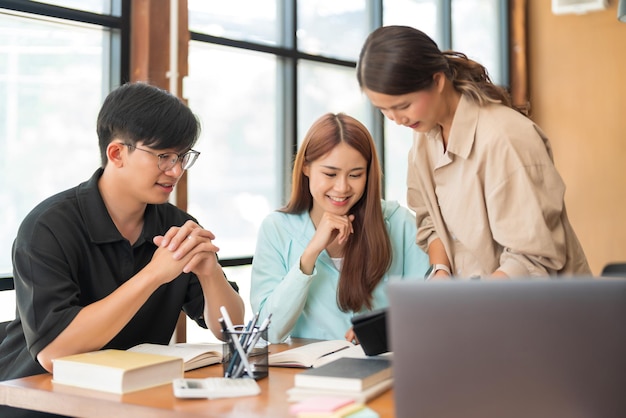 College education concept Female tutor pointing on tablet to tutoring math lessons to students