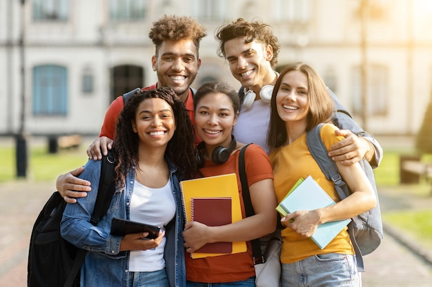 College friendship group of happy international students posing outdoors together