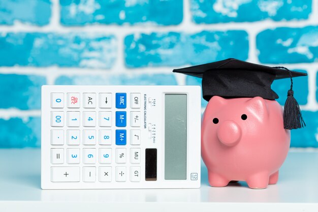 Photo college graduate student diploma piggy bank