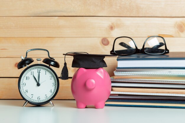 Photo college graduate student diploma piggy bank