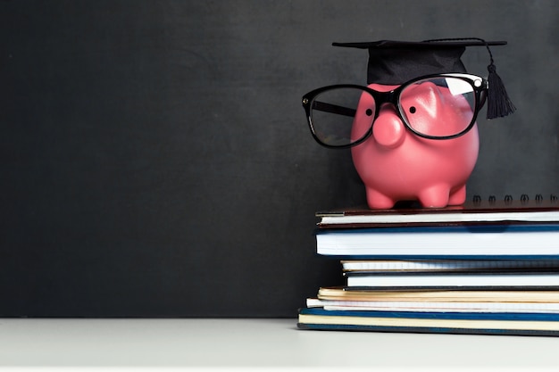 Photo college graduate student diploma piggy bank