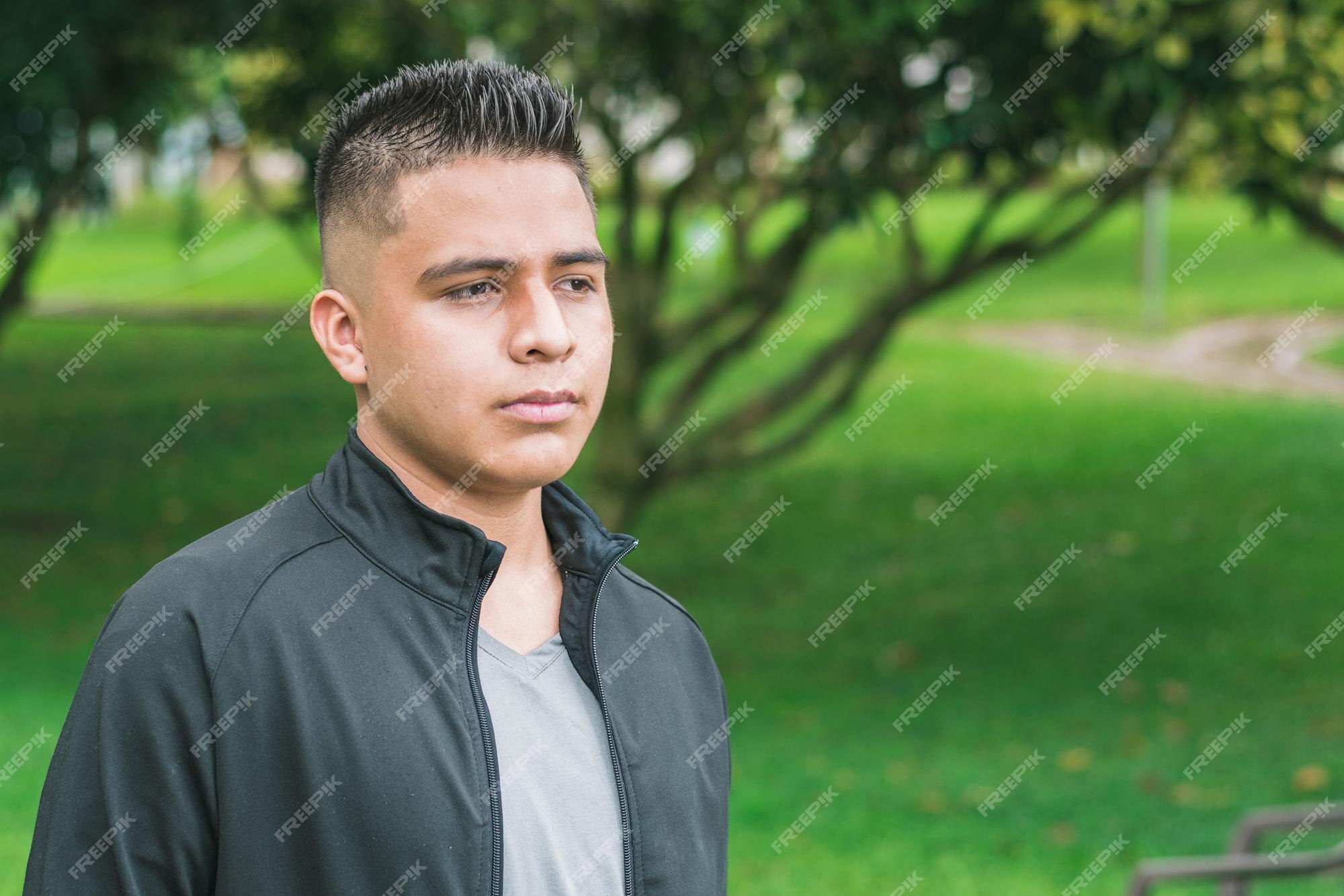 Premium Photo | College man with short hair and dressed in black taking a walk in a park thoughtful boy analyzing Premium Photo | College man with short hair and dressed in black taking a walk in a park thoughtful boy analyzing