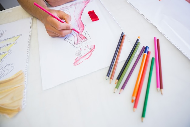 College student drawing picture with colored pencil