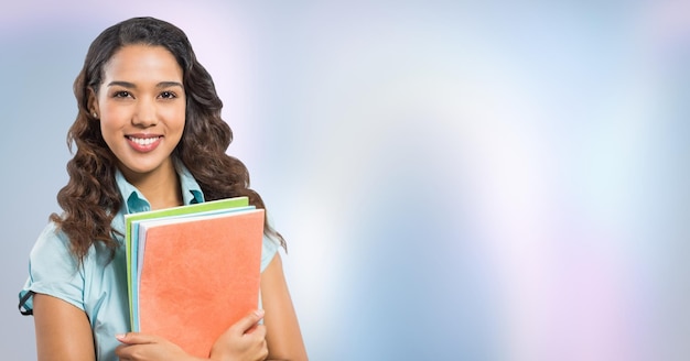 College student with books against purple abstract background