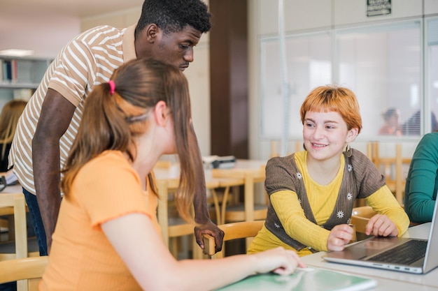 College students of different ethnicities studying together in the university library