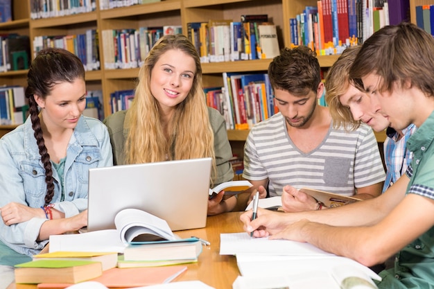 College students doing homework in library