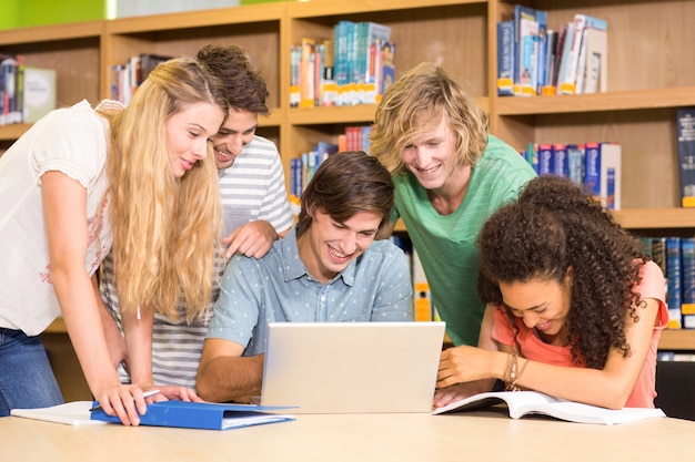 College students using laptop in library