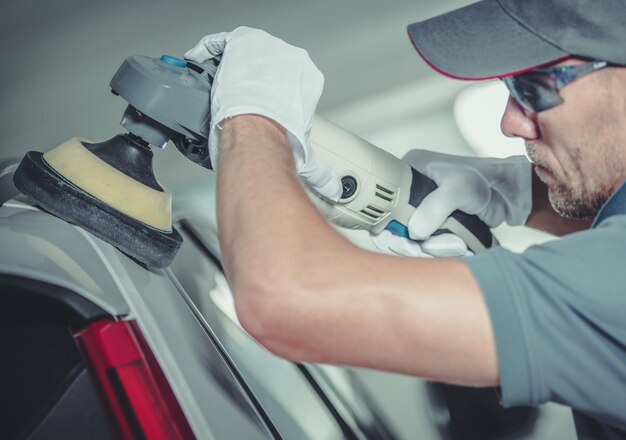 Photo collision center worker polishing car body