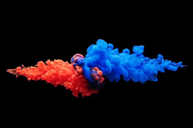 Photo collision of flow of red and blue ink on a black background. abstract concept photo