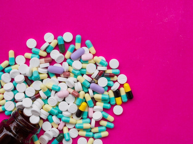 Coloeful pills spilling out of a pill bottle