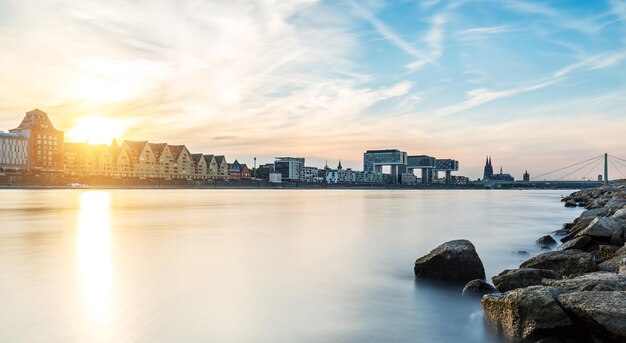 Cologne city panorama with cathedral and crane houses at sunset