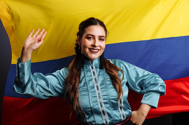 Colombian lady smiling and dancing against national flag of Colombia