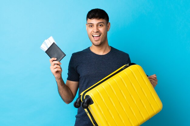 Colombian man isolated with travel suitcase