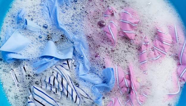 Color clothes soak in powder detergent water dissolution. Laundry concept