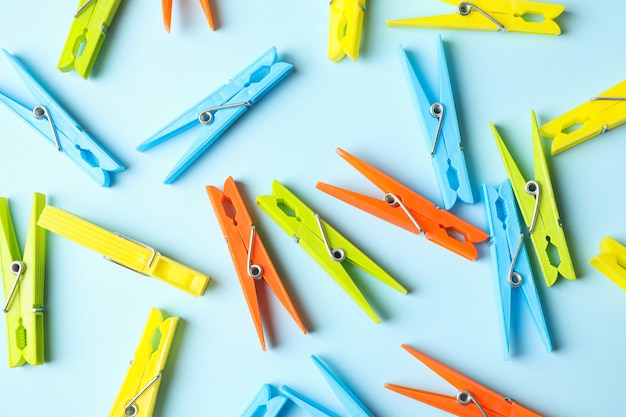 Color clothespins on blue, top view