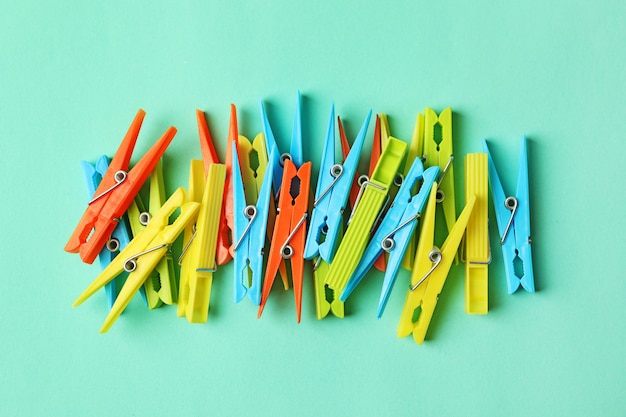 Color clothespins on mint, top view