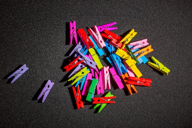 Color decorative clothespins on a black background
