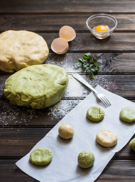 Color dough. Mint cookies. Orange cookies. Process of baking. Raw cookies. New Year
