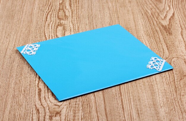 Color envelope on wooden background