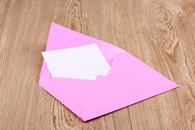 Color envelope on wooden background